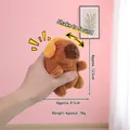 Brown Capybara plush keychain with orange earmuffs and internal sound-shaking function - Orange Headphones And The Screaming Capybara