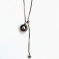 Elegant adjustable lariat necklace with a dark grey pearl pendant on silver snake chain - Iridescent Black Pearl