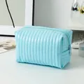 Sky blue quilted makeup bag with vertical stripes and zip closure for travel storage - Candy Leather Light Blue