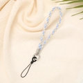 Detail of blue and beige woven phone wrist strap on soft fabric with metal ring - Light Blue