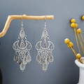 Bohemian silver drop earrings with intricate hollow patterns hanging on a branch - Vintage Tassel Teardrop (E1224-1)