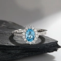 Elegant S925 sterling silver ring with oval blue gemstone and diamond halo setting - Topaz Oval Halo Style (LR305)