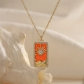 Macro view of gold tarot sun pendant with colorful zircon stones and orange enamel inlay - Sun - Orange