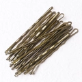 Pile of bronze-colored metal bobby pins for hair styling on white textured background - Wave Style / 50 Pieces / 5.0cm / Bronze