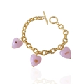 Detailed shot of golden link bracelet with pink heart glass pendants and OT toggle clasp - Bracelet / Pink