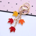 Detail of maple leaf keychain with colorful enamel pendants and golden metal spring clasp - Single OPP Bag Packaging / Multicolor