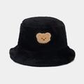 Detailed view of plush black faux fur fabric with a cute brown teddy bear patch - One Size / Black