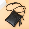 Women's black pebbled leather phone bag with triple zippers and tassel accents - Black