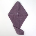 Detail of purple coral fleece hair towel with soft texture and matching secure button - Deep purple