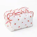 Quilted travel cosmetic bag with red cherry pattern and ruffle trim detail - White Lace Floral