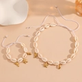Detail of white shell necklace and bracelet set with golden starfish and dolphin charms - White Rope Starfish Set