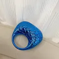 Detail of blue metallic clutch featuring diamond stitching and round hollow handle - Blue