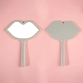 Grey lip-shaped handheld makeup mirrors with handle shown on pink background - 12*16 Light Green