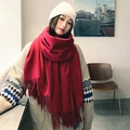 Red wool blend scarf with fringe details worn by a model in a professional studio setting - Wine Red