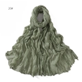 Detail shot of sage green crinkle texture scarf with natural frayed edges in soft gauze - 20# Green
