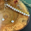 Natural freshwater pearl earrings and gold hair clip set displayed on a rustic wood slice - Pearl Hair Clip and Pearl Earrings