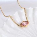 Pink marquise gemstone pendant on golden box chain displayed in white seashell tray - Leo