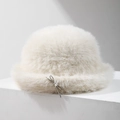 Plush faux fur bucket hat in cream white featuring a delicate silver bow accent - Beige