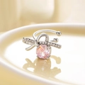 Silver bow-shaped ear cuff with pink faceted stone and small zircon accents - Right Ear / Pink (Peach)