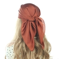 Detailed back view of a burnt orange satin headscarf tied as a stylish hair accessory - 70cm x 70cm / Caramel