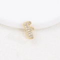 Macro view of gold letter F pendant featuring sparkling cubic zirconia stones on white texture - F (Single Pendant)