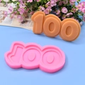 Close-up of number 100 silicone fondant mold with finished chocolate candy sample - Number 100
