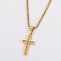 Close-up of golden cross pendant necklace with Jesus engraving on a white background - With Chain / Gold