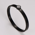 Macro shot of minimalist black stainless steel bangle with a sparkling clear zircon stone - Black 6mm
