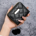 Quilted black leather coin purse with golden bar and soft fur ball charm detail - Black