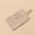 Close-up of muslin baby wipe pouch with moon print and snap button hanging strap - Khaki Moon