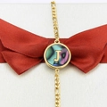 Gold-plated Figaro chain bracelet featuring a round abalone shell pendant with letter J - Letter J