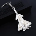 Silver fighter jet keychain in a sleek metal finish displayed on a black gift box - Camouflage J-20 Fighter Jet