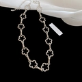 Detail of silver floral choker featuring hollow petal links and adjustable lobster clasp - Necklace-Silver-Flower