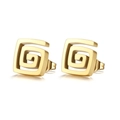 Detail macro view of golden square spiral earrings with polished finish on white background - Gold