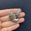 Natural gray striped conch shell pendant with gold ring displayed on fingers - No.18 (Grey Brown Striped Conch - Gold Metal Ring)