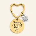 Golden heart keychain with Apple charm and 'Teaching is a work of Heart' engraving - JSYZ009 Teaching is a work of Heart / Gold