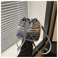Detail of adjustable blue leather strap and gold hardware on woven pattern bucket bag - Style 4