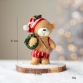 Miniature resin Christmas bear figurine holding a green wreath on snow base - Bear