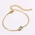 Detailed macro view of delicate gold bracelet featuring a round light blue gemstone inlay - Aqua Blue Zirconia (Round Aqua)