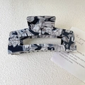 Large marble pattern acetate hair claw clip for elegant women hairstyles on beige background - Black and White