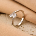 Elegant silver bow ring featuring two pear-cut cubic zirconia on a warm stone base - Silver Dual Pear Zirconia Ring (A-805)