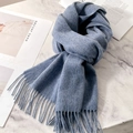 Elegant blue pure wool scarf with tassel trim displayed on a marble surface - Fog Blue