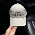Detail of beige cotton baseball cap with embroidered Keepit up text held by hand - L (58-61cm) / Light Khaki