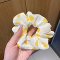 White organza scrunchie with yellow heart print held against a wooden background - Yellow Heart
