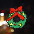 Christmas wreath window sticker featuring green glitter finish and festive red bow decoration - Christmas Wreath