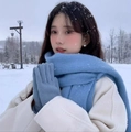 Blue mohair knit scarf and matching gloves set worn by a model in a winter snow setting - Solid Denim Blue