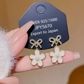 Elegant 925 silver bow and pearl flower earrings displayed on a black jewelry card - Gold Bowknot Flower
