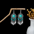 Detail of vintage bohemian earrings with turquoise beads and metallic teardrop tassels - E5861-2/Retro Hollow Teardrop Tassel