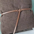Slim brown leather belt for women featuring a minimalist knot design on a textured surface - Caramel color