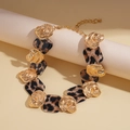 Detailed view of leopard print resin squares and gold textured metal links on necklace - Necklace / Gold Leopard Print
